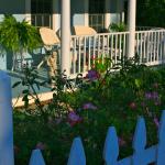 Relax on the side porch overlooking more gardens.
